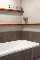 Grey tiles around bath