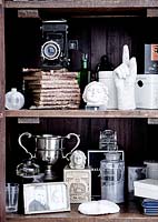 Vintage accessories and ornaments on wooden shelves