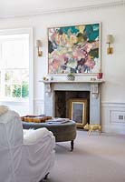 Modern painting above marble fireplace