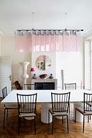 Modern dining room with designer furniture and pink suspended light by Johanna Grawunder
