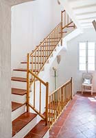 Staircase with whitewashed walls