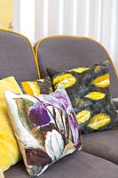 Colourful cushions made from vintage fabrics on Ercol sofa
