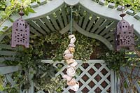 Arbour seat decorated with pebbles and lanterns