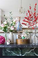 Flowers and accessories on marble mantlepiece