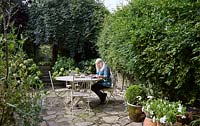 Janet Barbour sitting in her garden