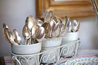Silver cutlery stored in pots