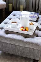 Tea tray on grey ottoman