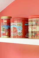 Colourful tins on kitchen shelf