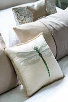 Embroidered cushions on bed