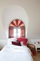 Arched window with curtains
