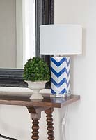 Patterned lamp on console table
