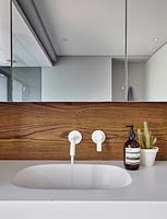 Modern bathroom sink with wooden splashback