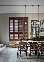 Open plan dining area with wooden shutters
