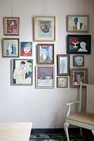 Colourful art display on dining room wall
