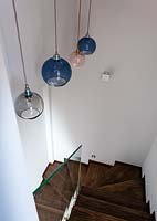 Glass pendant lights in stairwell