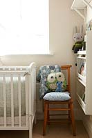 Wooden chair next to cot