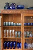 Glassware in wooden cabinet