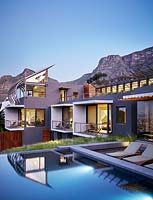 Contemporary house and pool lit up at dusk