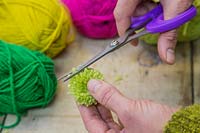 Making christmas pompom decorations - Trim the ends of your pompom to keep it neat and tidy 