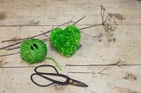 A green heart pompom made from wool