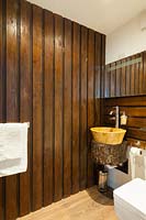 Timber clad wall in bathroom