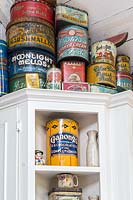 Vintage tins on kitchen shelves