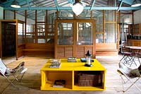 Open plan seating area with yellow coffee table