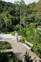 Tropical garden with paved area and statues