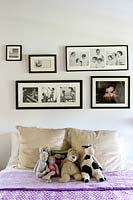 Family photo display above bed
