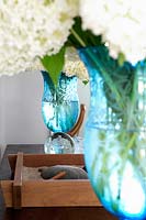 Turquoise vases with white flowers