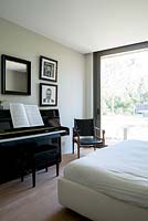 Modern bedroom with piano