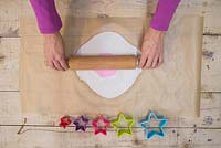 Making clay stars - Lay the silicone flower mould on top of the modelling clay, and gently use the rolling pin to add a light impression from the mould