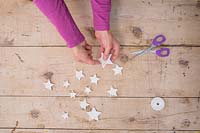 Making clay stars - Adding string to the stars so they can be hung