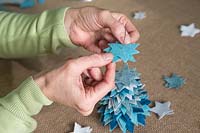 Making a felt christmas tree - Add the felt stars to the thin wire in size order from large to small