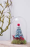 A christmas tree decoration made from wire and coloured felt with moss and felt reindeers