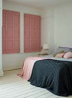 Pink shutters in bedroom