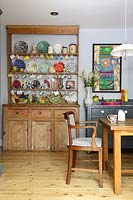 Colourful crockery display on wooden dresser