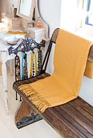 Yellow throw on wooden bench