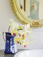 Orchid flowers in antique jug