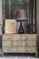 Glass lamp on chest of drawers