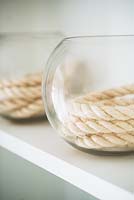 Coiled rope in glass vase