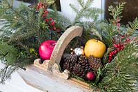 Christmas decorations in wooden trug