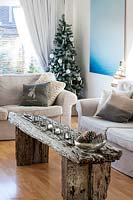 Christmas decorations on rustic coffee table. Aluminium photograph by Harry Cory Wright
