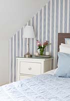 White lamp on bedside cabinet