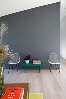 Designer chairs against grey wall