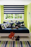 Colourful cushions on childs bed