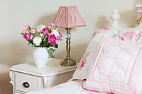 Jug of Roses and Carnations on bedside cabinet