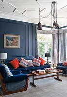 Colourful cushions on blue sofa