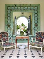 Floral armchairs by mirror