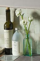 White Ranunculus flowers in glass bottle